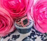 Rose Gold Bezel Set Dark Blue Topaz with Surrounding Pink Sapphire Ring