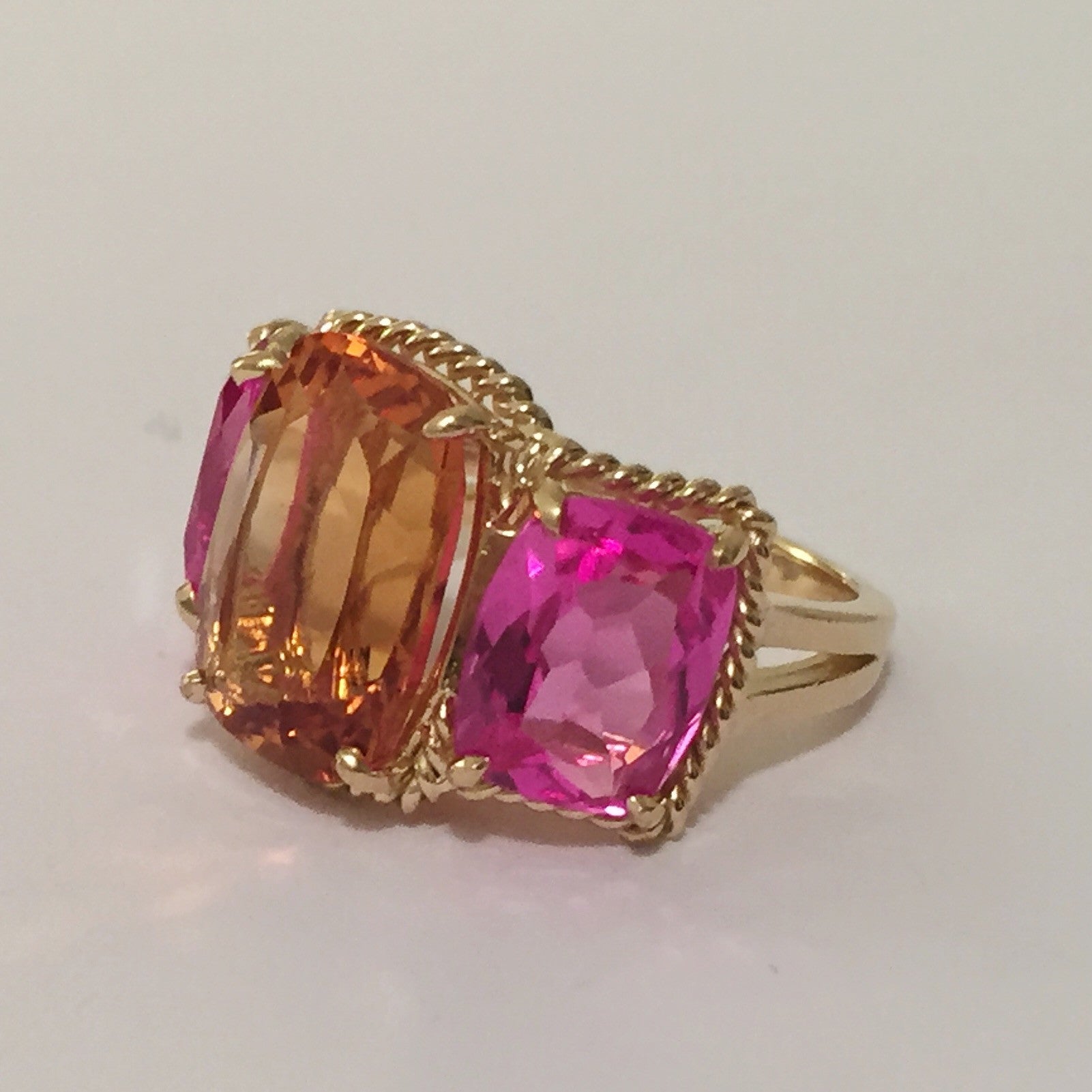 18kt Yellow Gold Three Stone Ring with Pink Topaz and Blue Topaz and Rope Twist Border